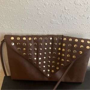 Medium sized cognac clutch with a should strap